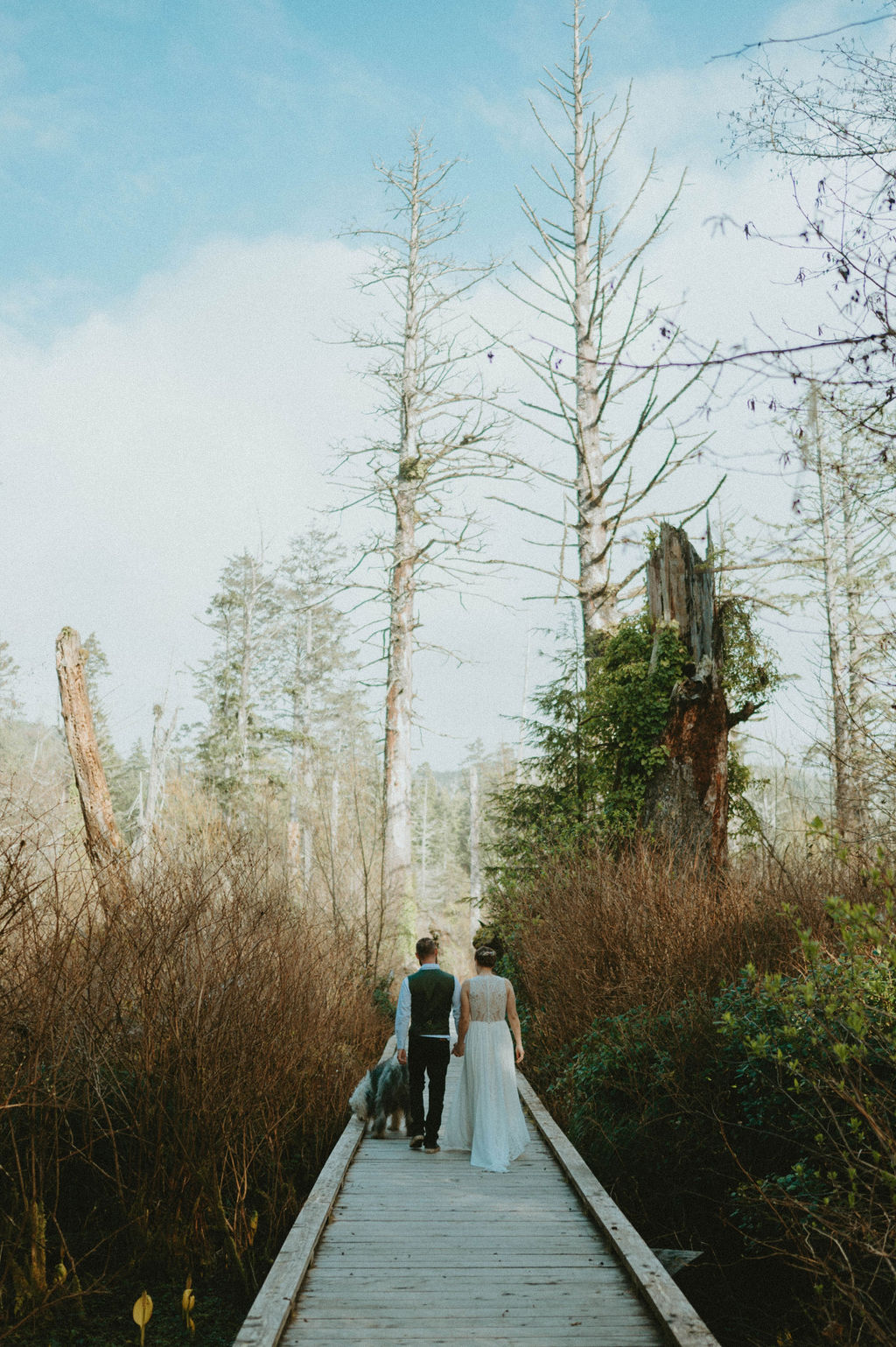 couple walking on bridge during oregon elopement at hug point