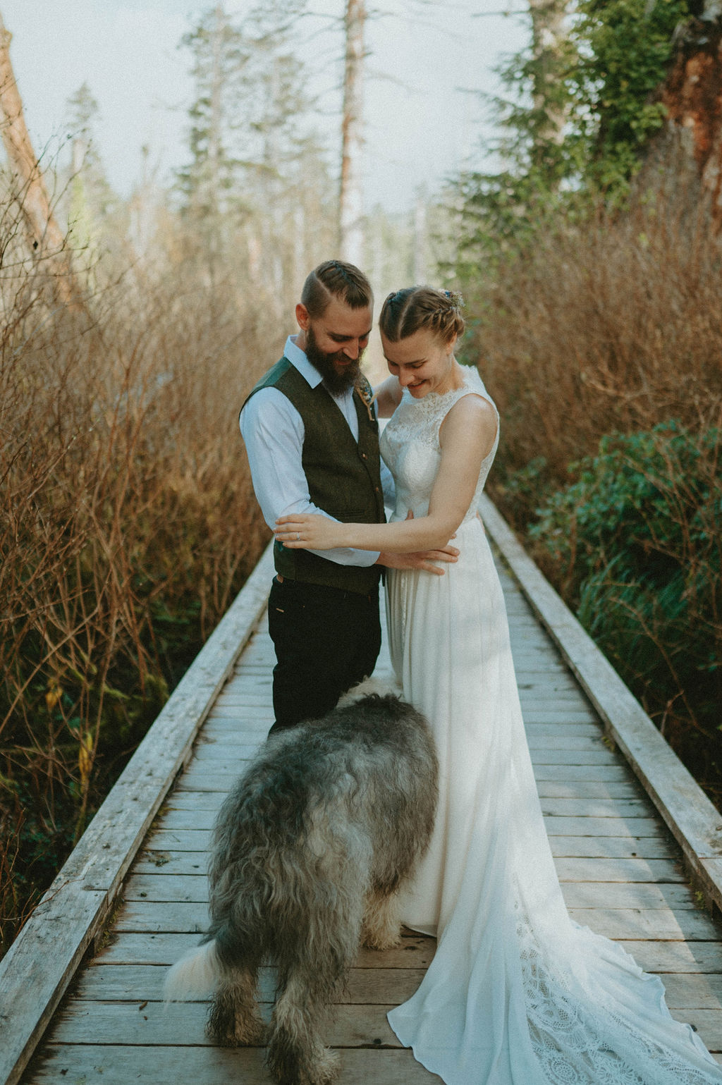 couple with dog at cannon beach during elopement