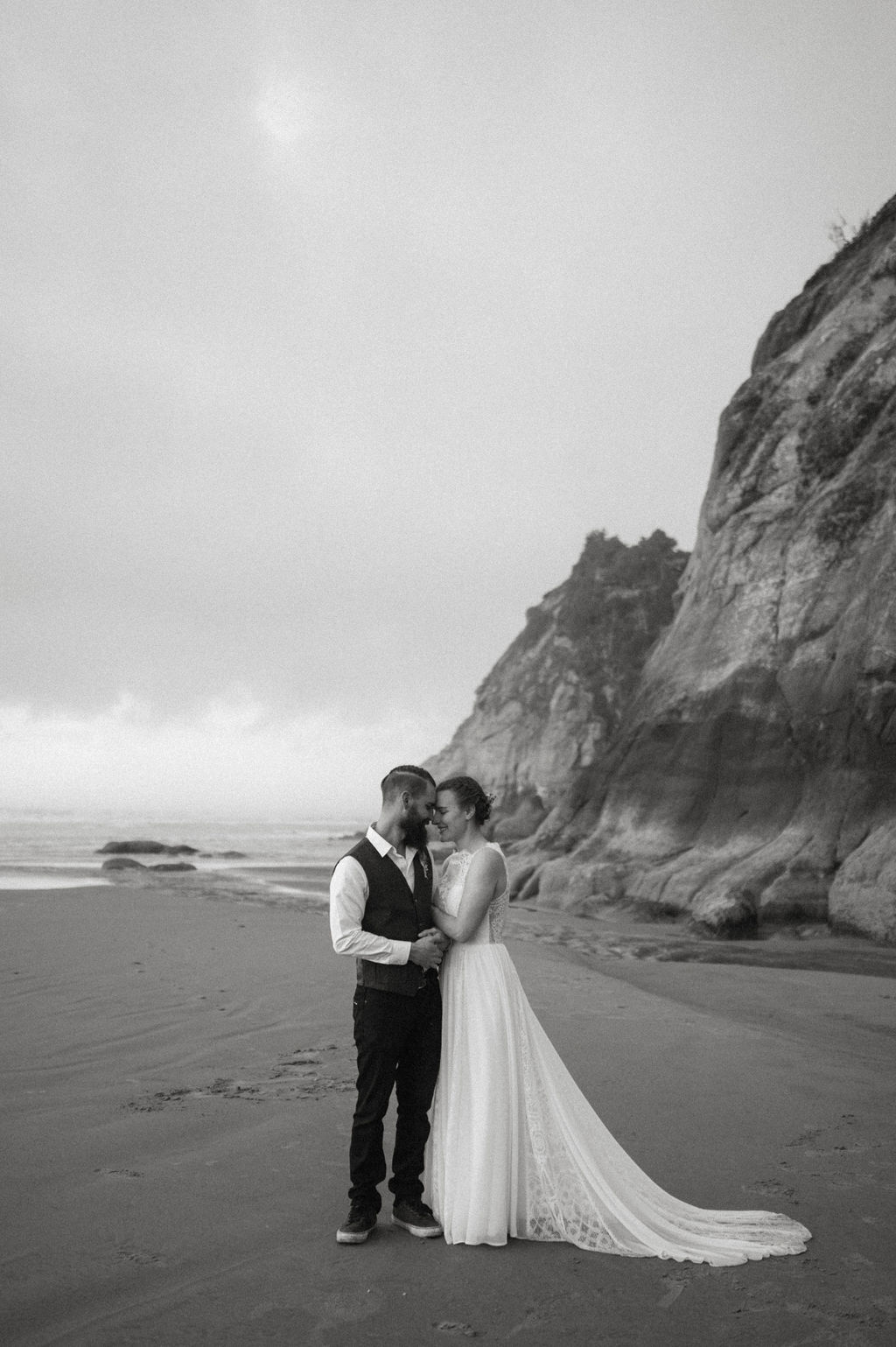 couple hugging during beach elopement in oregon